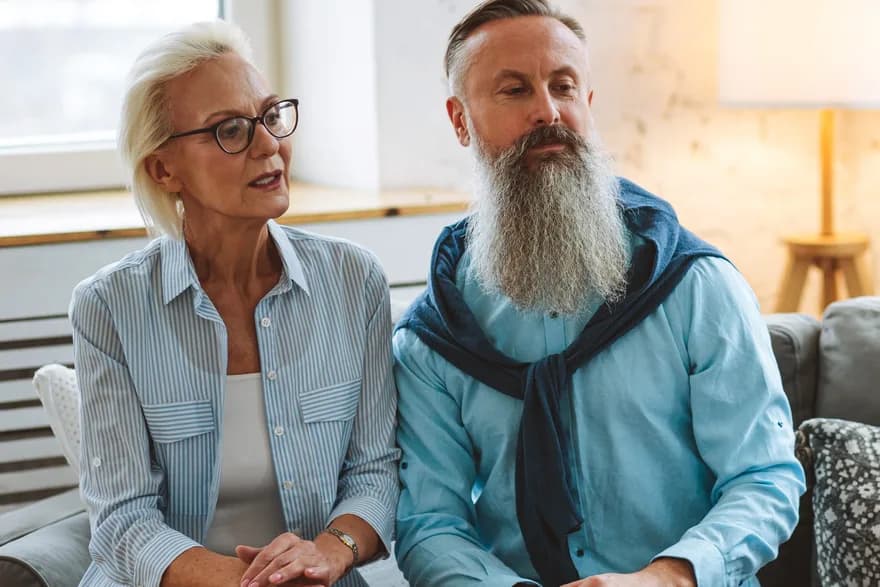 An older couple sitting side by side in conversation